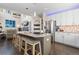 Open concept kitchen with a large island, stainless steel appliances, and modern lighting at 20234 E Lake Cir, Centennial, CO 80016