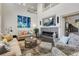 Spacious living room with a cozy fireplace, large windows, and a view of the upper level at 20234 E Lake Cir, Centennial, CO 80016