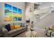 Open living room with stairs to second level, neutral walls, and bright, colorful wall art at 20234 E Lake Cir, Centennial, CO 80016