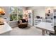 Bright home office featuring a comfortable chair, built-in shelving, and a large window with backyard views, ideal for productivity at 20234 E Lake Cir, Centennial, CO 80016