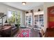 Inviting home office with a comfortable sofa, large window, and built-in bookshelves at 20234 E Lake Cir, Centennial, CO 80016