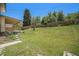 Spacious, grassy backyard with a covered patio and wood fence at 8346 W Woodard Dr, Lakewood, CO 80227