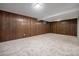 Basement area with wood paneling on the walls, neutral carpet, and recessed lighting for ample illumination at 8346 W Woodard Dr, Lakewood, CO 80227