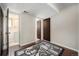 Basement area with tile flooring, a decorative rug, and access to another room with sink at 8346 W Woodard Dr, Lakewood, CO 80227