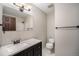 Bathroom features a vanity and a white tiled shower with bronze fixtures at 8346 W Woodard Dr, Lakewood, CO 80227
