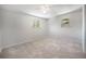 Empty bedroom featuring carpeted floors and natural light from two windows at 8346 W Woodard Dr, Lakewood, CO 80227