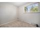 Cozy bedroom with neutral walls, plush carpeting, a window for natural light, and baseboard heating at 8346 W Woodard Dr, Lakewood, CO 80227