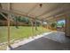 Spacious covered patio looks out to a well-maintained lawn and fenced backyard at 8346 W Woodard Dr, Lakewood, CO 80227