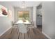 Stylish dining room with modern wood floors, a sliding glass door and modern light fixture at 8346 W Woodard Dr, Lakewood, CO 80227