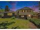Charming two-story home with a brick facade, complemented by a well-manicured lawn and lush greenery at 8346 W Woodard Dr, Lakewood, CO 80227