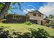 Charming two-story home with a brick facade, complemented by a well-manicured lawn and lush greenery at 8346 W Woodard Dr, Lakewood, CO 80227