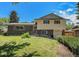 Charming two-story home with a brick facade, complemented by a well-manicured lawn and lush greenery at 8346 W Woodard Dr, Lakewood, CO 80227