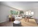 Bright living room featuring neutral walls, wood floors, and large windows offering scenic outdoor views at 8346 W Woodard Dr, Lakewood, CO 80227