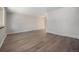 Open concept living room with modern wood floors, neutral walls, and ample natural light at 8346 W Woodard Dr, Lakewood, CO 80227