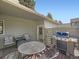 Back patio featuring a table set with chairs, a grill, and a fire pit for outdoor gatherings at 3002 E Long S Cir, Centennial, CO 80122