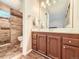 Well-lit bathroom featuring a vanity, mirror, and tiled shower at 3002 E Long S Cir, Centennial, CO 80122