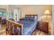 Comfortable bedroom with wood floors, a queen bed, and natural light at 3002 E Long S Cir, Centennial, CO 80122