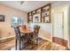 Charming dining area features a round table, wood floors, and built-in shelving at 3002 E Long S Cir, Centennial, CO 80122