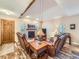 Cozy living room with a fireplace, vaulted ceiling, wood floors and comfortable seating at 3002 E Long S Cir, Centennial, CO 80122