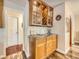 Wet Bar featuring custom wood cabinets, granite counters, and glass shelving at 3002 E Long S Cir, Centennial, CO 80122