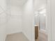 Walk-in closet with wire shelving and view to a bright and modern bathroom at 20665 E 57Th Dr, Aurora, CO 80019