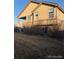 View of the rear exterior featuring a covered deck and walkout basement at 3903 S Quemoy Ct, Aurora, CO 80018