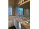 Bright bathroom features a double sink vanity, large mirror, and a window for natural light at 3903 S Quemoy Ct, Aurora, CO 80018