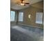 Spacious bedroom features neutral walls, vaulted ceiling with fan, and natural light from three large windows at 3903 S Quemoy Ct, Aurora, CO 80018