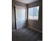 A cozy bedroom with neutral walls, carpeted floor, and sliding closet doors at 3903 S Quemoy Ct, Aurora, CO 80018