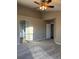 Carpeted bedroom includes ceiling fan, neutral walls, and entryway to the bathroom at 3903 S Quemoy Ct, Aurora, CO 80018
