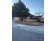 A cozy single-story house framed by a wooden fence and mature trees at 3903 S Quemoy Ct, Aurora, CO 80018