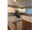 Updated kitchen featuring white cabinets, stainless steel appliances, and granite countertops at 3903 S Quemoy Ct, Aurora, CO 80018