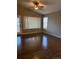 Open living space with hardwood floors, bright windows, and a modern ceiling fan at 3903 S Quemoy Ct, Aurora, CO 80018