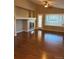Bright living room featuring a fireplace, large windows, and gleaming hardwood floors at 3903 S Quemoy Ct, Aurora, CO 80018