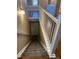 Carpeted staircase with white railing leading to a finished basement at 3903 S Quemoy Ct, Aurora, CO 80018