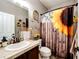 Charming bathroom with sunflower themed shower curtain and rustic decor at 11699 Pink Phlox Dr, Parker, CO 80134
