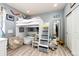 Cozy bedroom with a loft bed, a comfortable chair and an adjacent mirror at 11699 Pink Phlox Dr, Parker, CO 80134