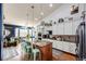 Bright kitchen with long island, bar seating, granite countertops and stainless steel appliances at 11699 Pink Phlox Dr, Parker, CO 80134