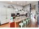 Bright kitchen with long island, bar seating, granite countertops and stainless steel appliances at 11699 Pink Phlox Dr, Parker, CO 80134
