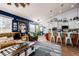 Open concept living room featuring a fireplace, wood floors, and seamless flow to the kitchen at 11699 Pink Phlox Dr, Parker, CO 80134