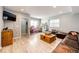 Open living area with a large wooden chest, leather sofa, and ample natural light at 11699 Pink Phlox Dr, Parker, CO 80134