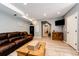 Relaxing living room with hardwood floors and comfortable leather sofa at 11699 Pink Phlox Dr, Parker, CO 80134