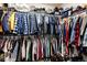 Spacious walk-in closet featuring clothing racks with hanging clothes and shelving with folded items at 11699 Pink Phlox Dr, Parker, CO 80134