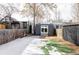 Private backyard with detached studio and snowy grass at 1838 Race St, Denver, CO 80206