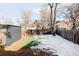 Cozy backyard with wooden fence, patchy grass, and brick patio at 1838 Race St, Denver, CO 80206