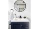 Modern bathroom with navy vanity, round mirror, and shower at 1838 Race St, Denver, CO 80206