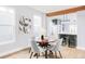 Bright dining area with wood table and gray chairs, open to kitchen at 1838 Race St, Denver, CO 80206