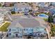 Aerial view of green townhome exteriors, parking, stone accents and a pool area at 9461 Ashbury Cir # 104, Parker, CO 80134