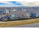 Aerial view of townhomes showcasing exteriors, streetscapes, parking and nearby mountains at 9461 Ashbury Cir # 104, Parker, CO 80134