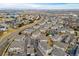 Aerial view showcasing residential streetscapes, landscaping and community pool at 9461 Ashbury Cir # 104, Parker, CO 80134